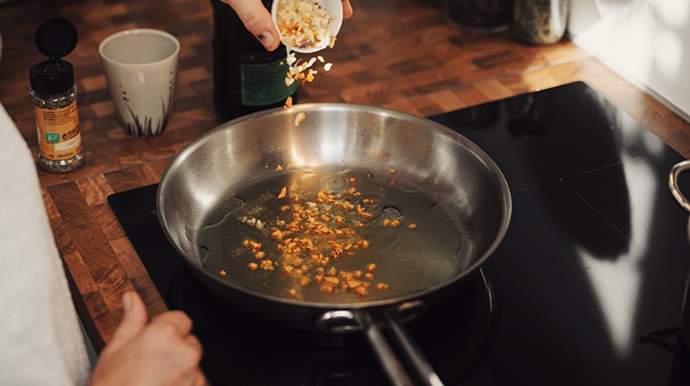 person cooking on an induction stovetop