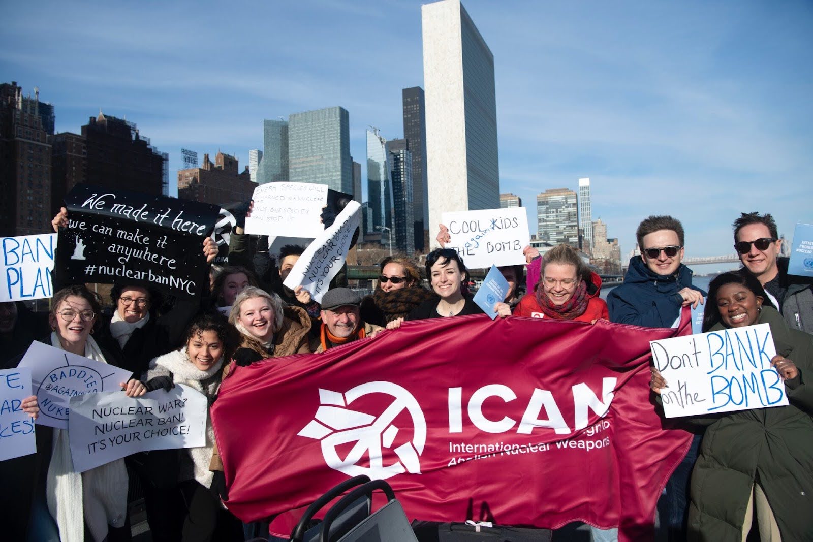 Campaigners holding an ICAN banner with the UN building in the background