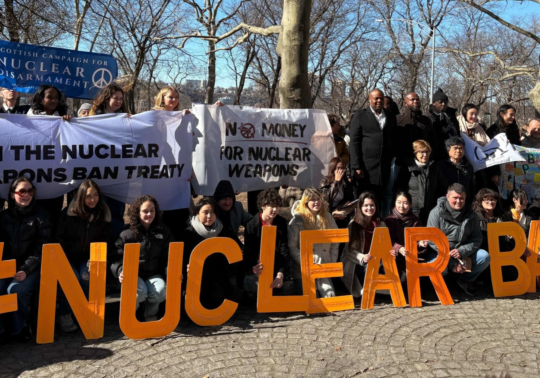 ICAN activists with letters spelling out "Nuclear Ban"