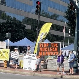 Protestors hold banners reading "Nuclear Weapons are illegal" and "Stop the Nuclear Madness"