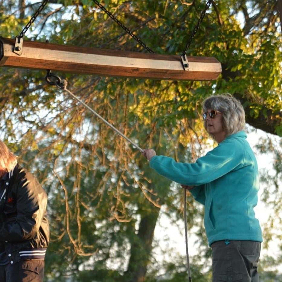 A woman rings a large bell